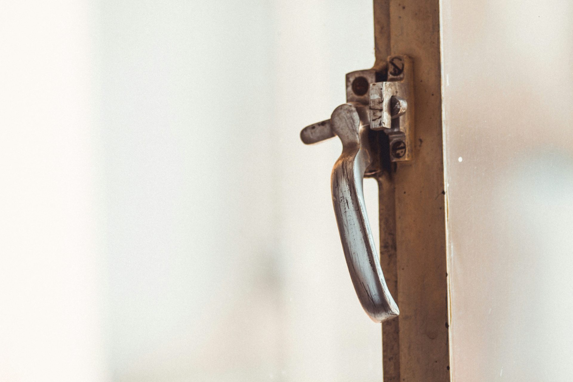 grey metal door lever in close up photography