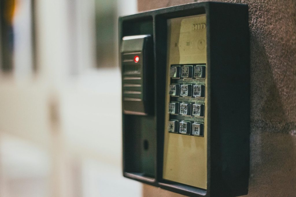 Close-up of a security access control keypad with illuminated buttons for keyless entry.