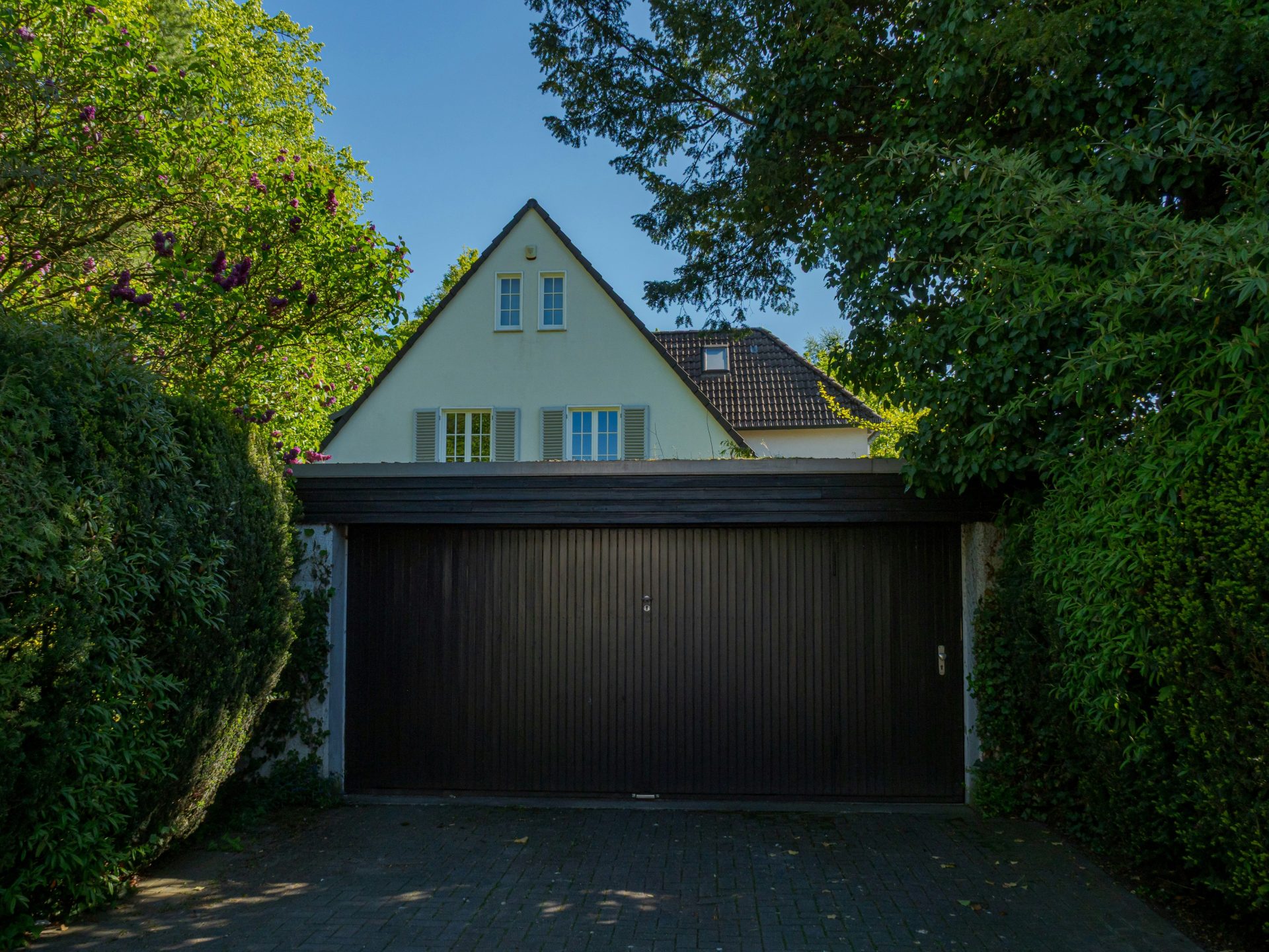 A house with a large dark garage door.